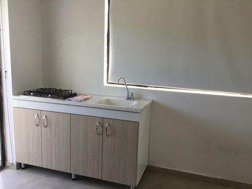 a bathroom with a sink and a mirror at Apartamento Opaa in San Andrés