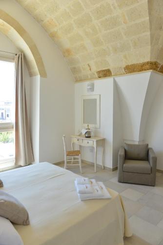 a bedroom with a bed and a chair and a desk at Tobacco Suite in Mesagne