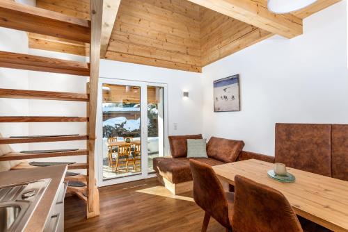 a living room with wooden ceilings and a table and chairs at Apartment 5 Peaks in Zell am See