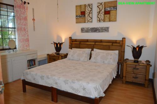 a bedroom with a large bed and two night stands at Sea-view Apartment in Christ Church