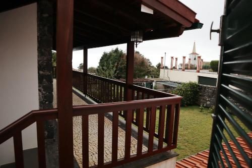a wooden balcony with a view of a building at Casa D'Avo Beatriz in Gaula