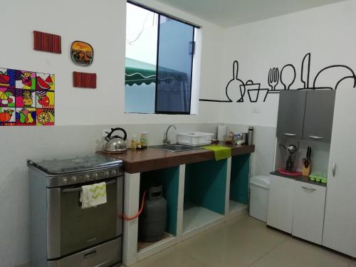 uma cozinha com um balcão, um lavatório e uma janela em Hostal Brisa Marina em Paracas