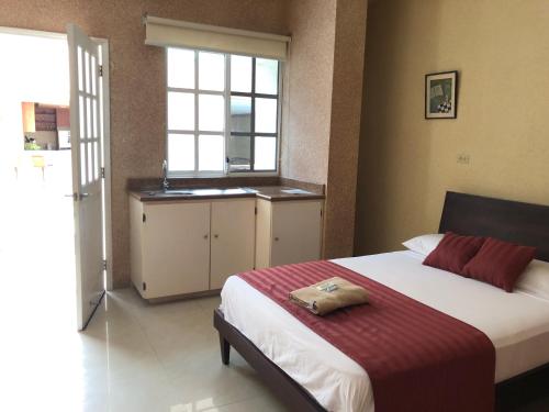 a bedroom with a bed and a sink in it at Eco Hotel Katarma in Puerto Baquerizo Moreno