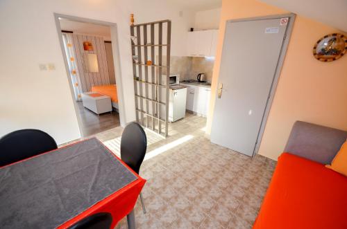 a room with a table and chairs and a kitchen at Apartment The Sea Coast in Kotor