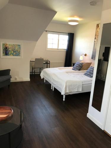 a bedroom with a bed and a couch and a table at Rasta Lilla Edet in Lilla Edet