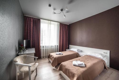Postel nebo postele na pokoji v ubytování Sergeev Hotel