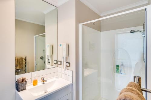 a white bathroom with a sink and a shower at Napier B&B - Tequila Sunrise in Eskdale