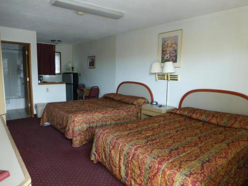 a hotel room with two beds in a room at Umatilla Inn & Suites in Umatilla