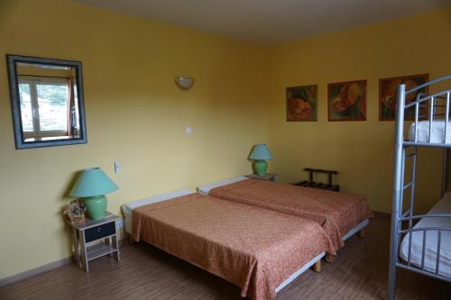 a bedroom with a bed and two lamps and a ladder at Gîte des Grands Causses in Millau