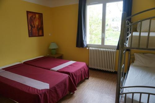 a bedroom with two beds and a bunk bed at Gîte des Grands Causses in Millau