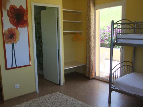 a bedroom with a bunk bed and a door leading to a closet at Gîte des Grands Causses in Millau