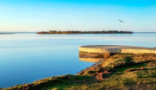 a large body of water with a bird flying over it at Mandurah Quay Resort in Mandurah
