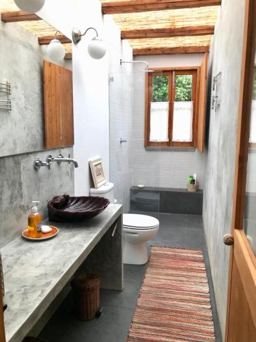 a bathroom with a sink and a toilet at #Areias Houses 9 in Furnas