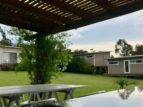 a picnic table in the backyard of a house at Hjem Studios in La Pedrera
