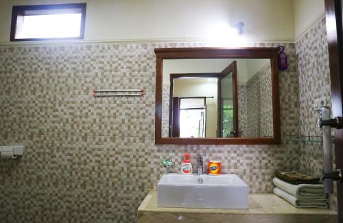 a bathroom with a sink and a mirror at Two Brothers Villa in Gili Air