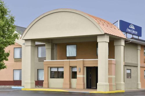 a hotel building with an arch over the entrance at Howard Johnson by Wyndham Allentown/Dorney Hotel & Suites in Allentown