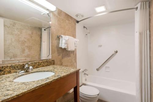 a bathroom with a sink and a toilet at Ramada by Wyndham State College Hotel & Conference Center in State College