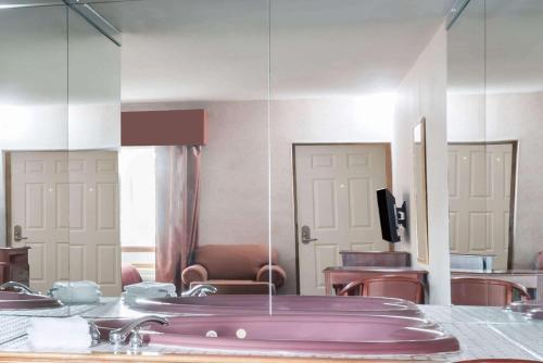 a bathroom with a purple sink and a mirror at Howard Johnson by Wyndham Lenox in Lenox