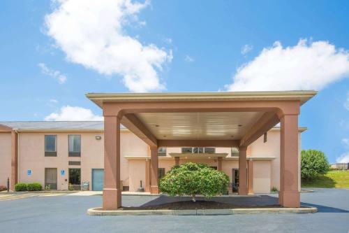 a building with a large garage in a parking lot at Howard Johnson by Wyndham Beckley in Beckley