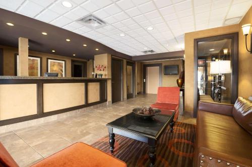a lobby with a waiting room with couches and a table at Ramada by Wyndham Surrey/Langley in Surrey