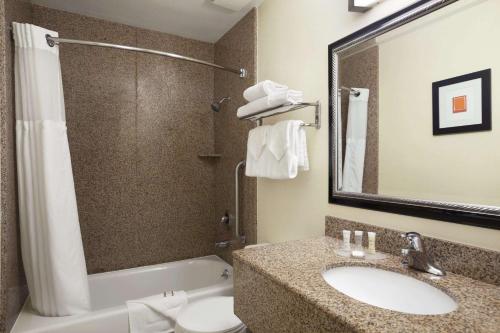 a bathroom with a sink and a toilet and a shower at Howard Johnson by Wyndham San Diego Sea World in San Diego