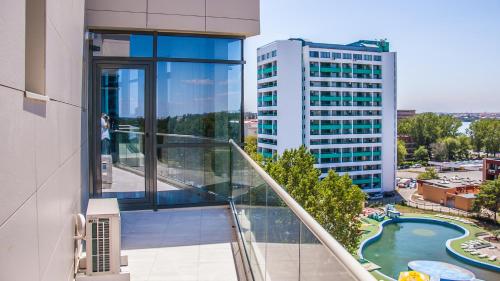 an apartment balcony with a view of a building at Riviera Residence Apartments in Mamaia