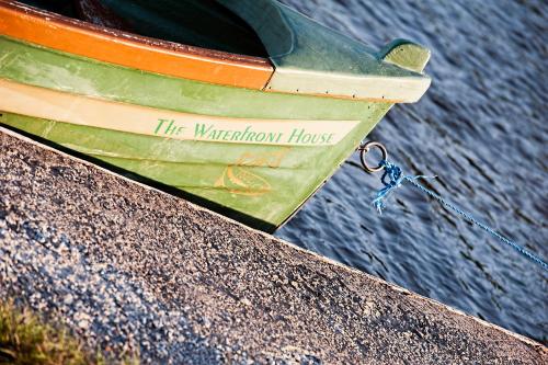 a boat sitting on top of the waterthrow house at The Waterfront House Country Home in Oughterard