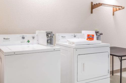 a bathroom with two washing machines and a sink at Ramada by Wyndham Panama City in Panama City