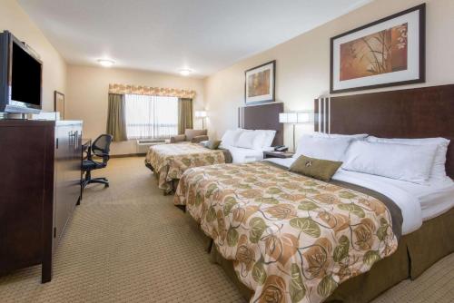 A bed or beds in a room at Ramada by Wyndham Wainwright