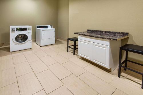 a laundry room with a washer and a washing machine at Microtel Inn and Suites North Canton in North Canton
