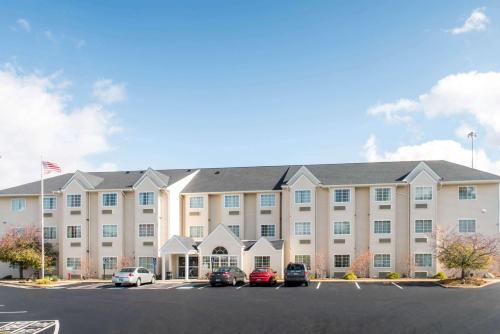 a large building with cars parked in a parking lot at Microtel Inn and Suites North Canton in North Canton