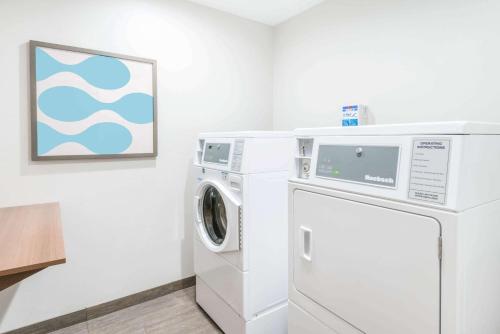 a washing machine and a dryer in a room at Microtel By Wyndham Victor in Victor