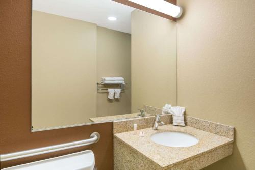 a bathroom with a sink and a mirror at Microtel Inn and Suites North Canton in North Canton