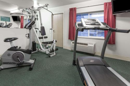 a fitness room with a treadmill and a gym at Microtel Inn & Suites Modesto in Ceres