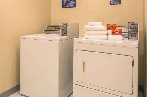 a laundry room with a washer and dryer with towels at Microtel Inn and Suites Ocala in Ocala