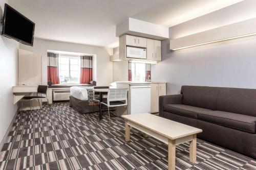 a small living room with a couch and a table at Microtel Inn & Suites Modesto in Ceres