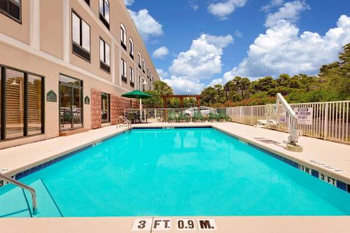 a swimming pool in front of a building at Wingate by Wyndham Destin in Destin