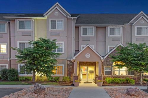 a large house with a driveway in front of it at Microtel Inn & Suites by Wyndham Jasper in Jasper