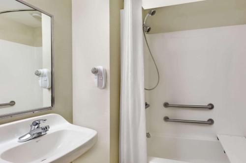 a bathroom with a sink and a shower at Microtel Inn & Suites by Wyndham Tuscaloosa in Tuscaloosa