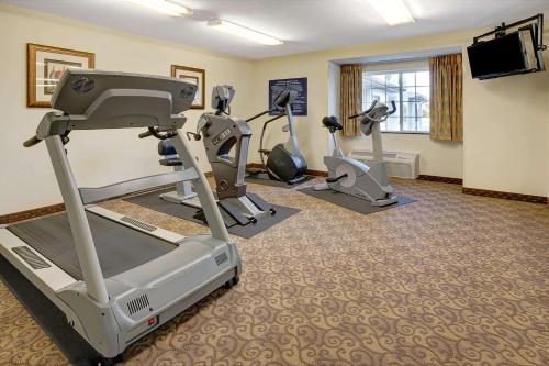 a fitness room with treadmills and exercise bikes at Microtel Inn & Suites by Wyndham Indianapolis Airport in Indianapolis
