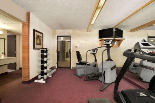 a room with a gym with a treadmill at Ramada by Wyndham Lethbridge in Lethbridge