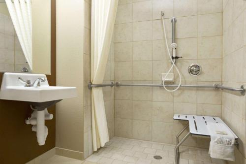 uma casa de banho com um lavatório e um chuveiro em Microtel Inn & Suites by Wyndham Odessa TX em Odessa