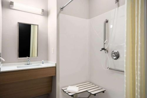 a bathroom with a sink and a shower at Microtel Inn & Suites by Wyndham in Lynchburg