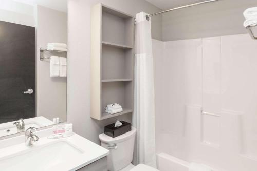 W łazience znajduje się toaleta, umywalka i prysznic. w obiekcie Microtel Inn & Suites by Wyndham West Fargo Near Medical Center w mieście West Fargo