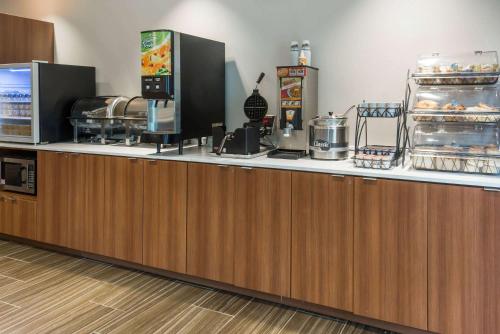 a kitchen with a counter with food on it at Microtel Inn & Suites by Wyndham Altoona in Altoona