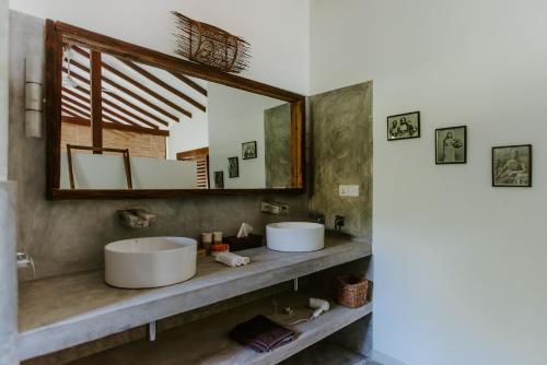 a bathroom with two sinks and a large mirror at Vanina Villas in Matara