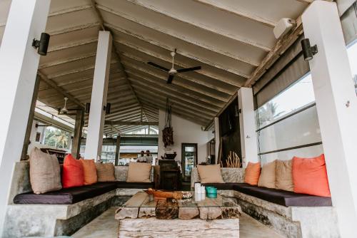 an outdoor living room with couches and a table at Vanina Villas in Matara
