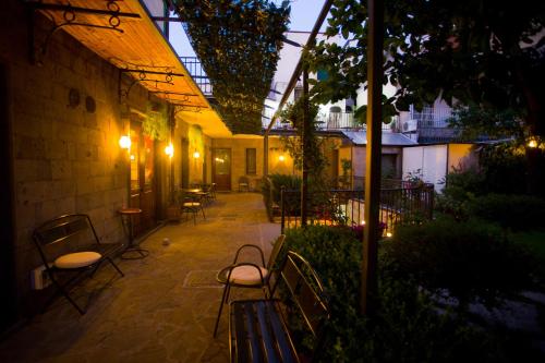 a patio with benches and tables in a building at Hotel Pace in Pompei