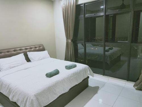 a bedroom with a bed with two pillows on it at Sky Loft Premium Bukit Indah with Garden View & Nflix HBO A30 in Johor Bahru
