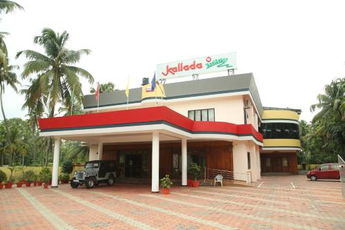 a building with a car parked in front of it at Kallada Residency in Kodungallūr
